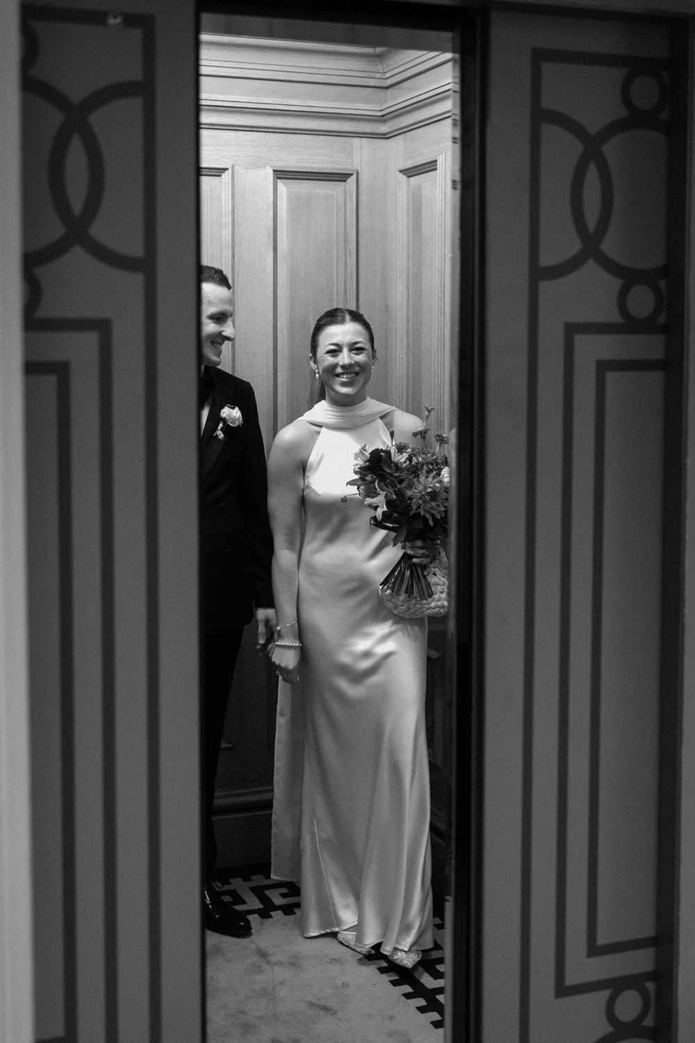 Bride and groom in a lift together at The Landmark London.