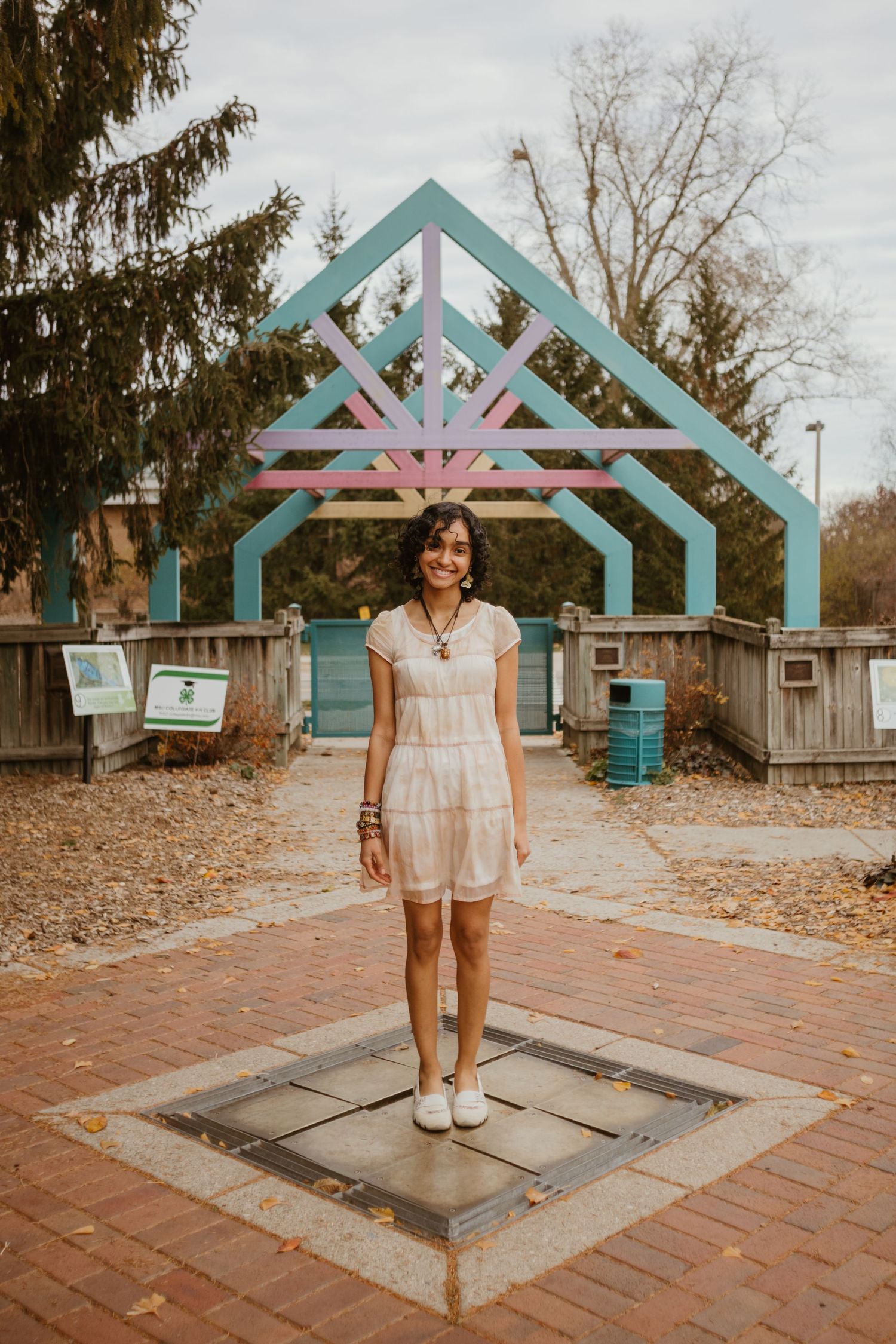 A series of photos showing a decorative teal archway entrance on a brick pathway in an outdoor setting.