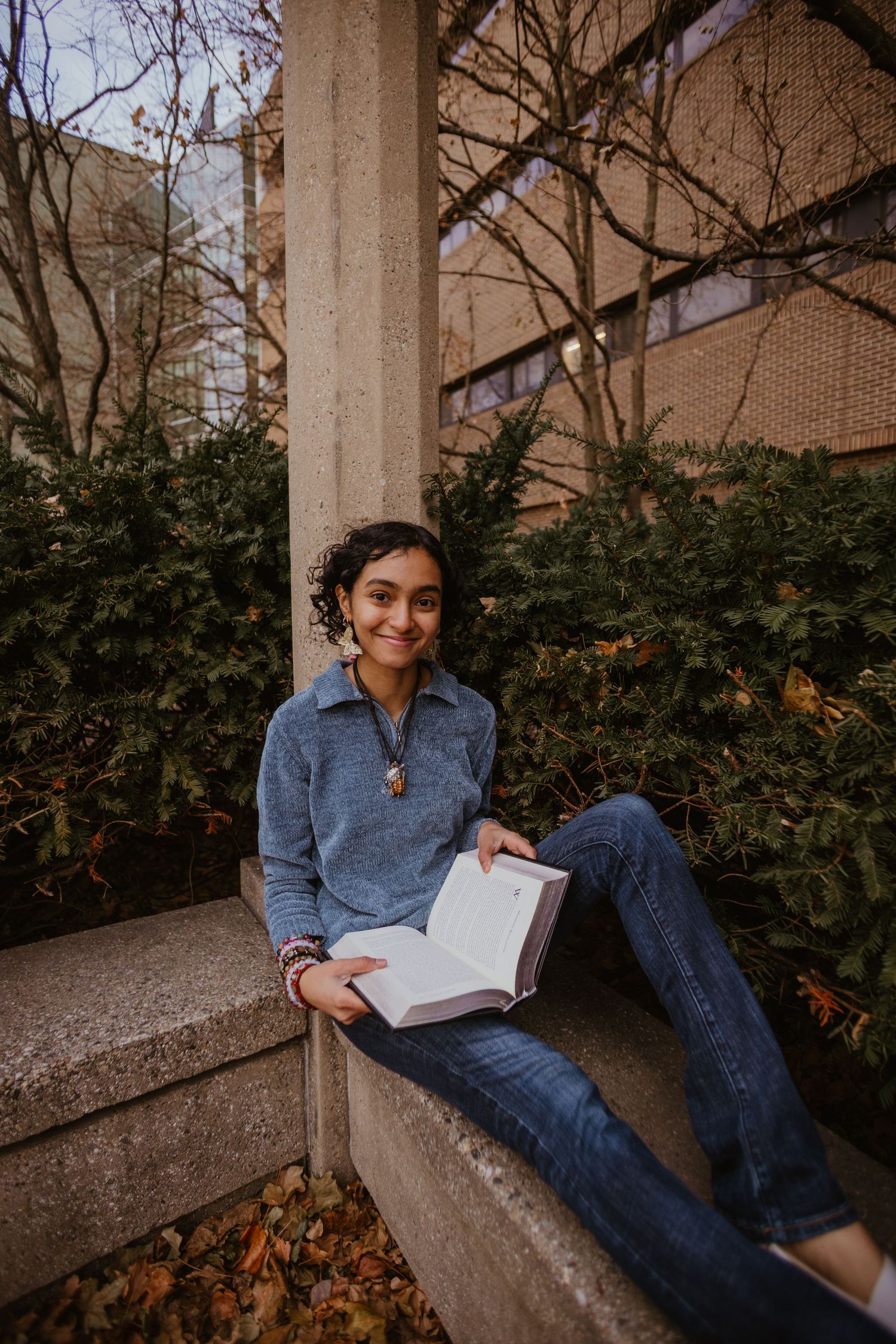 A series of casual outdoor photos showing someone relaxing and reading on a concrete ledge near some bushes.