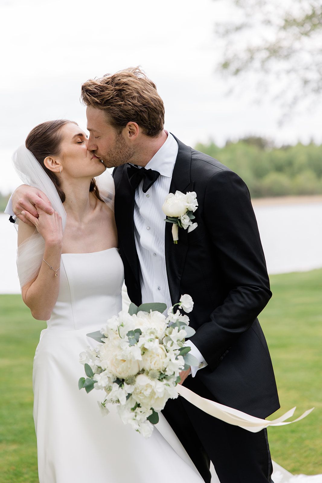 A romantic wedding couple shares intimate kisses outdoors with white floral bouquet in a series of photos.