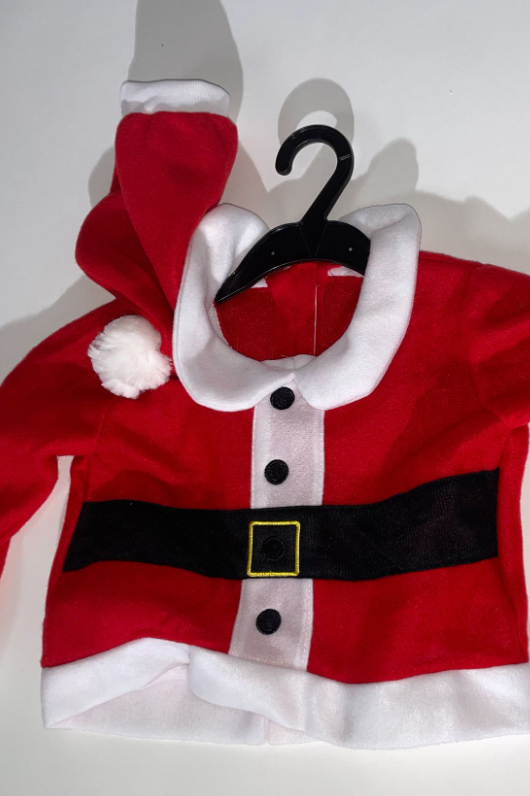 Red and white Santa Claus costume laid flat showing belt and buttons on light background.