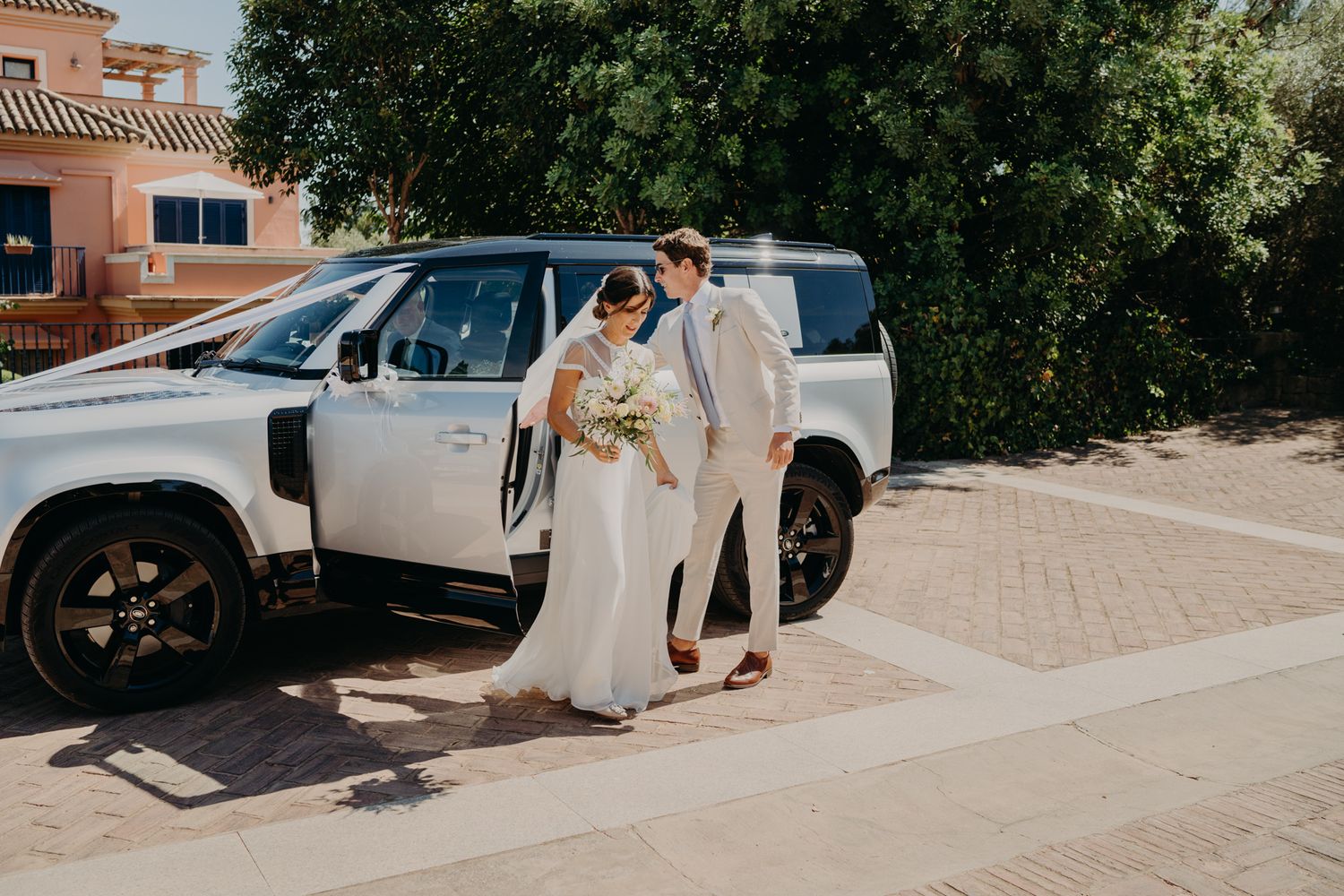 White Land Rover Defender as luxury wedding transportation.