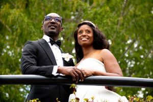 A happy couple shares a joyful moment together outdoors during their wedding celebration.