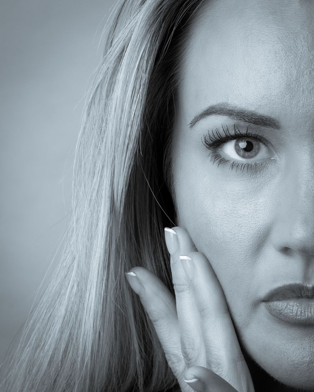 A close-up artistic black and white portrait study showing the face partially cropped in different segments.