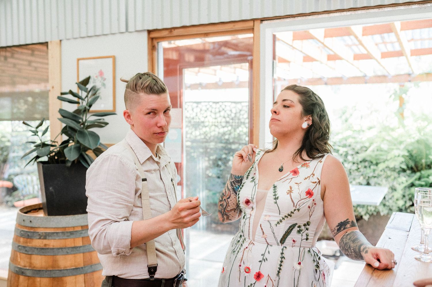 candid moment between two brides after eating cake during their Washington elopement.