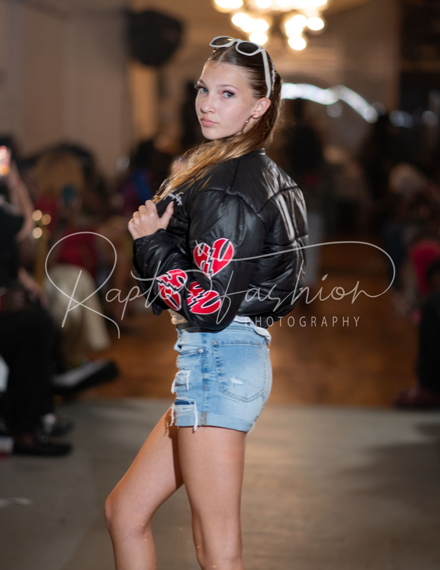 Casual denim and leather look with sunglasses on fashion runway.