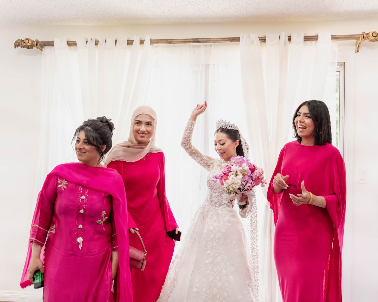 Radiant bride surrounded by her bridesmaids, all smiles. Calgary wedding.