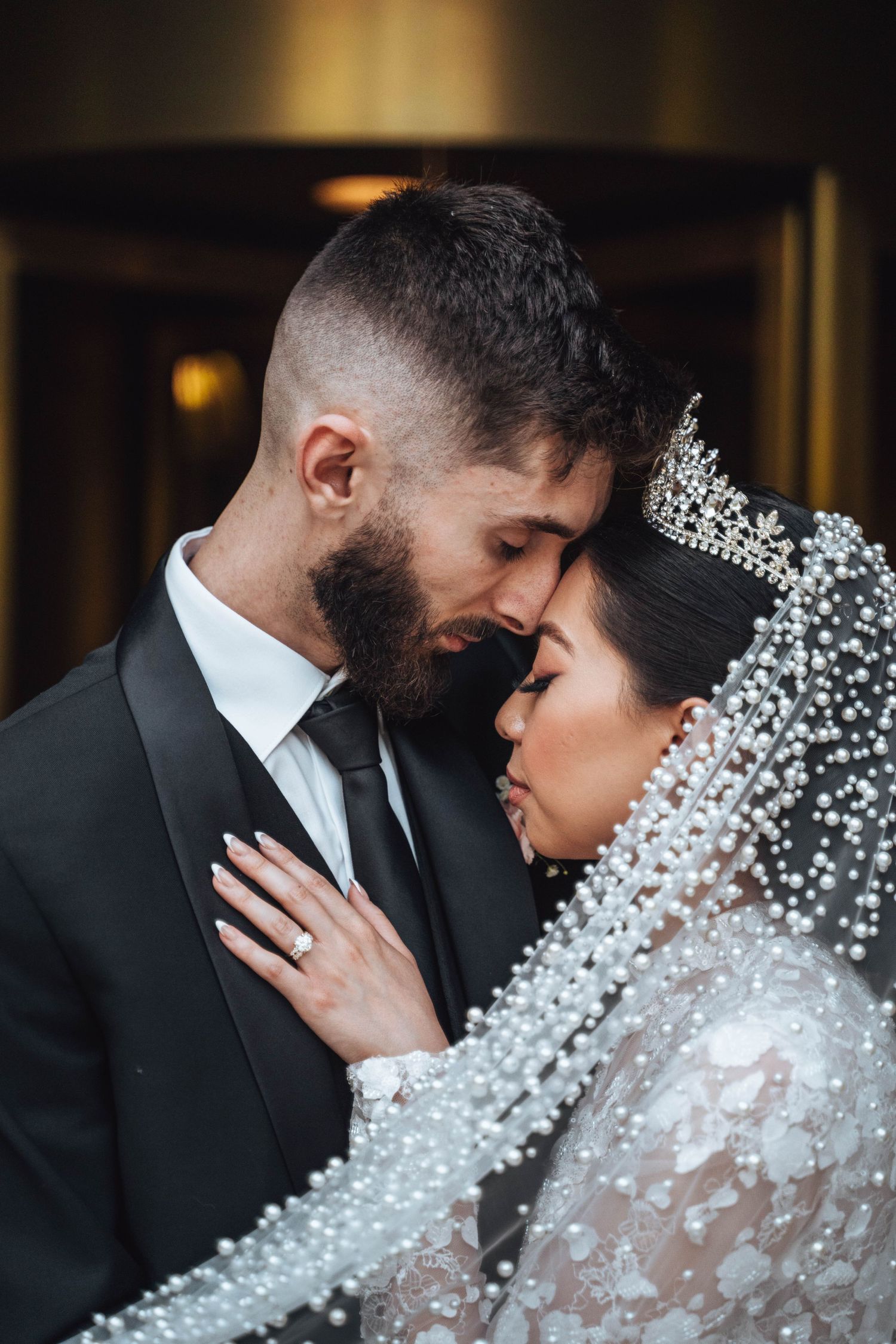 Tender embrace between bride and groom, eyes closed, radiating joy. Calgary wedding.