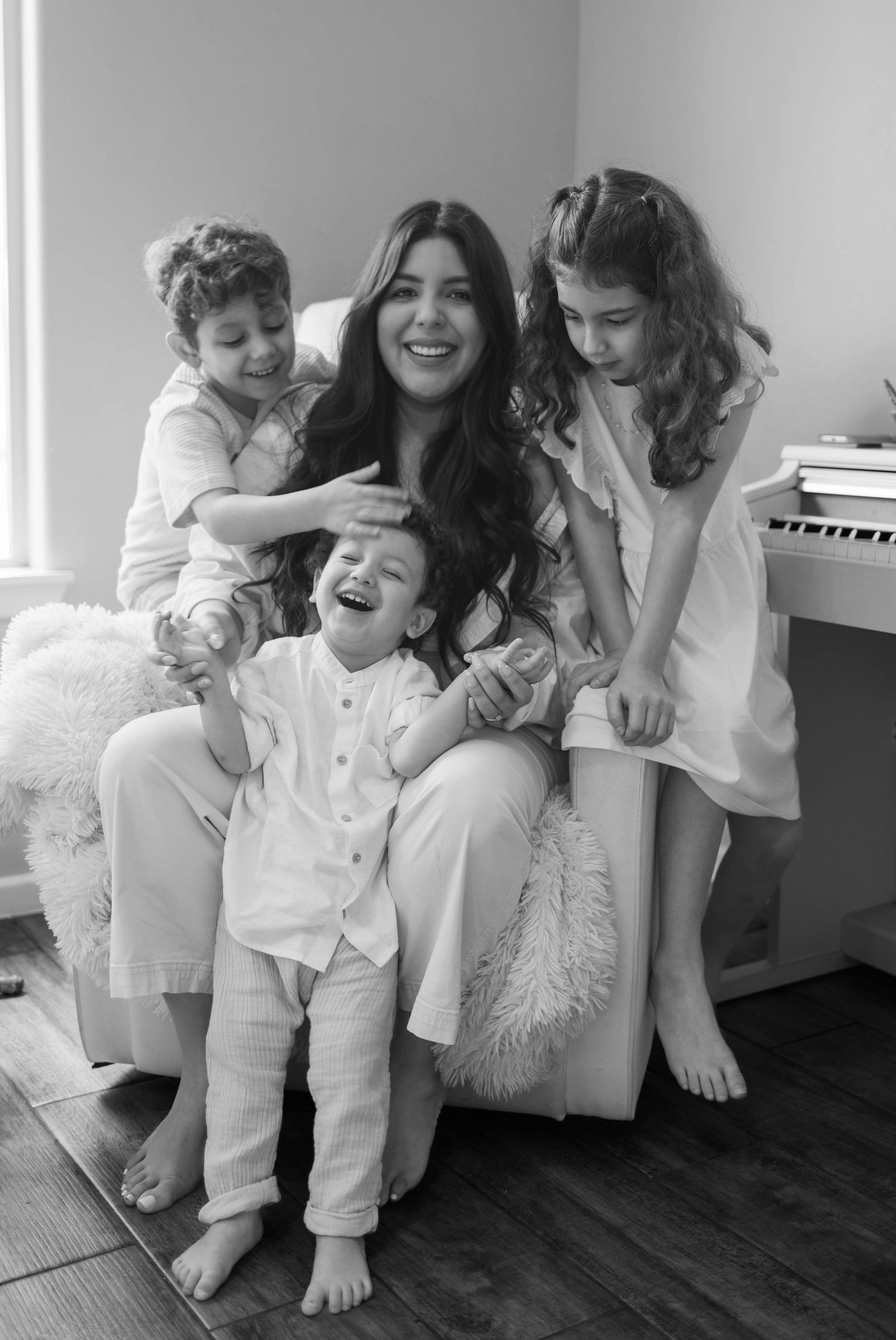 A candid moment of a stay-at-home mom bonding with her kids during a family lifestyle session in Cary, North Carolina