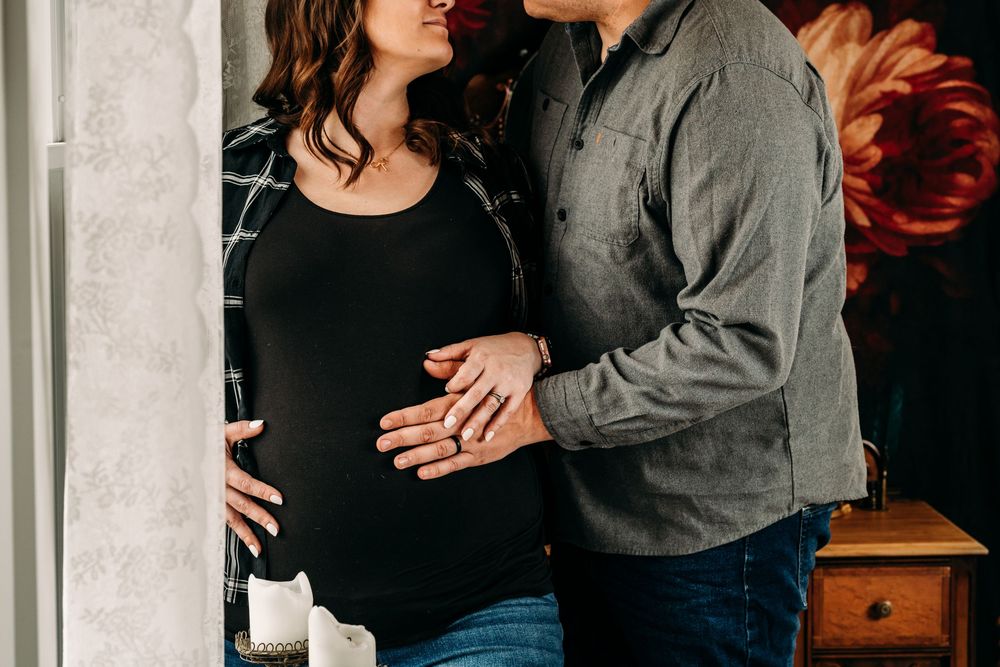 A romantic couple in casual attire embraces family. Creative Photographer, Grand Rapids MI