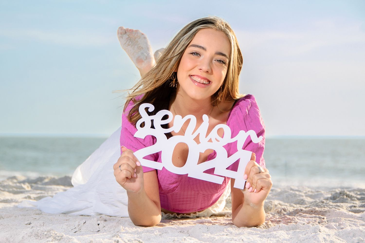 Senior picture of girl lying in sand in New Port Richey