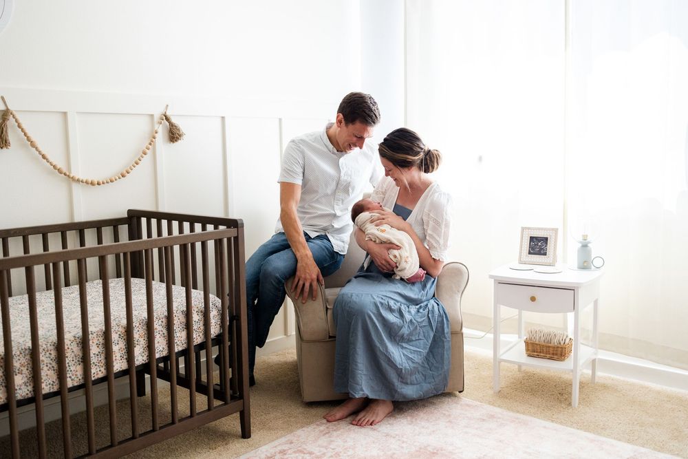 A series of nursery photos showing a dark wooden crib, rocking chair, and tender moments between parents and baby.