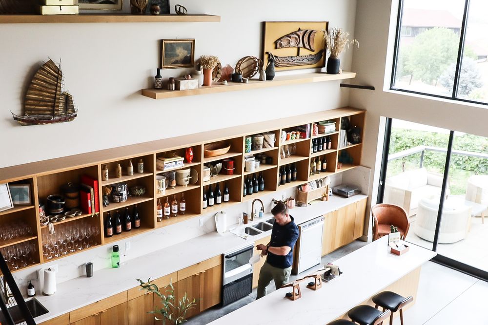 Aerial view of a modern wine tasting room with built-in shelving and retail display.