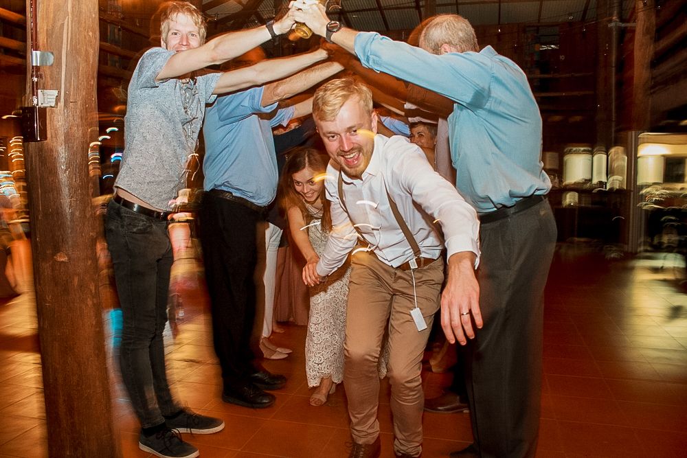 Wedding guests form a fun tunnel arch formation on the dance floor at a reception celebration.Jasper SkyTram, Jasper Pizza & Pub