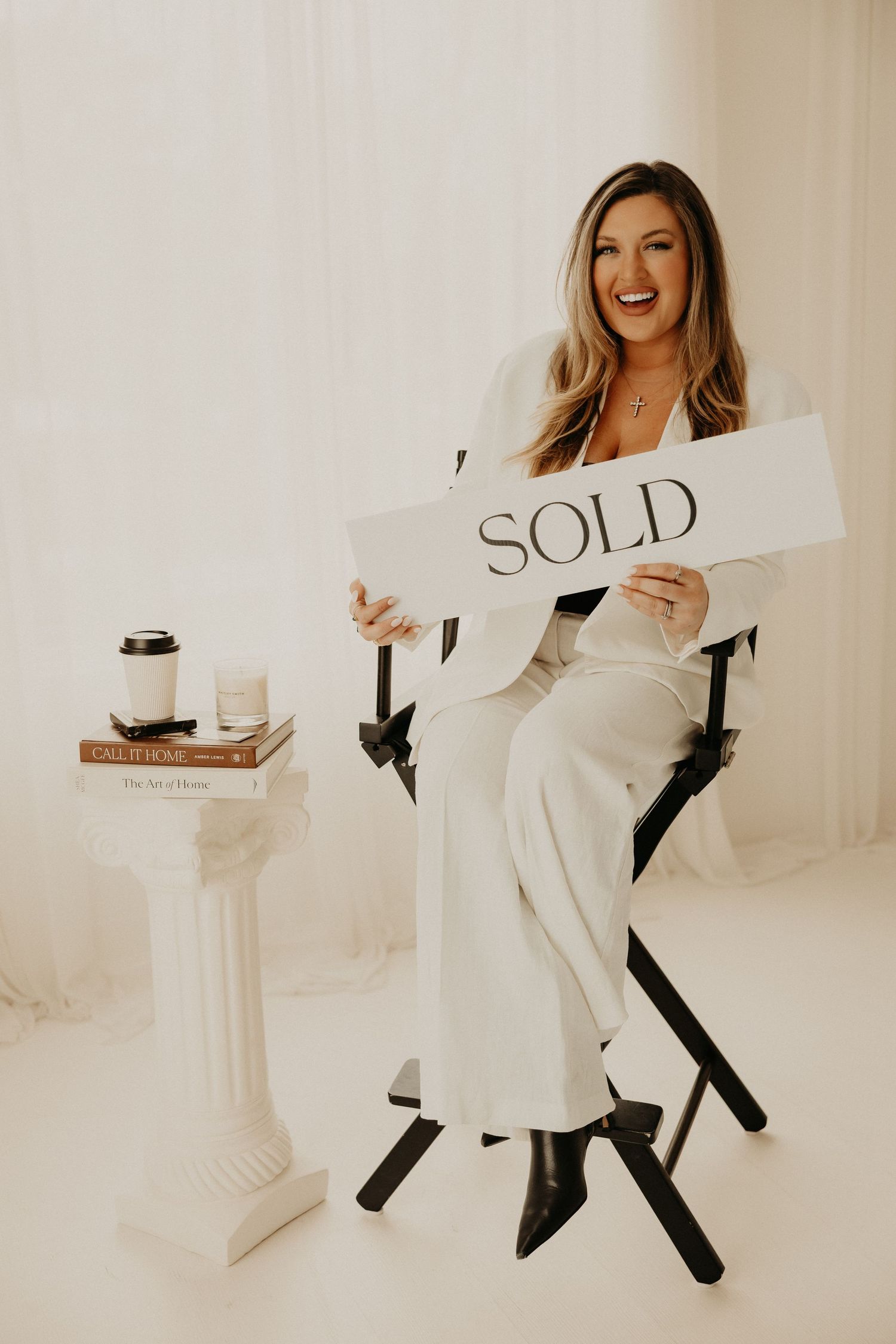Professional branding photoshoot of a woman entrepreneur in a modern office setting.