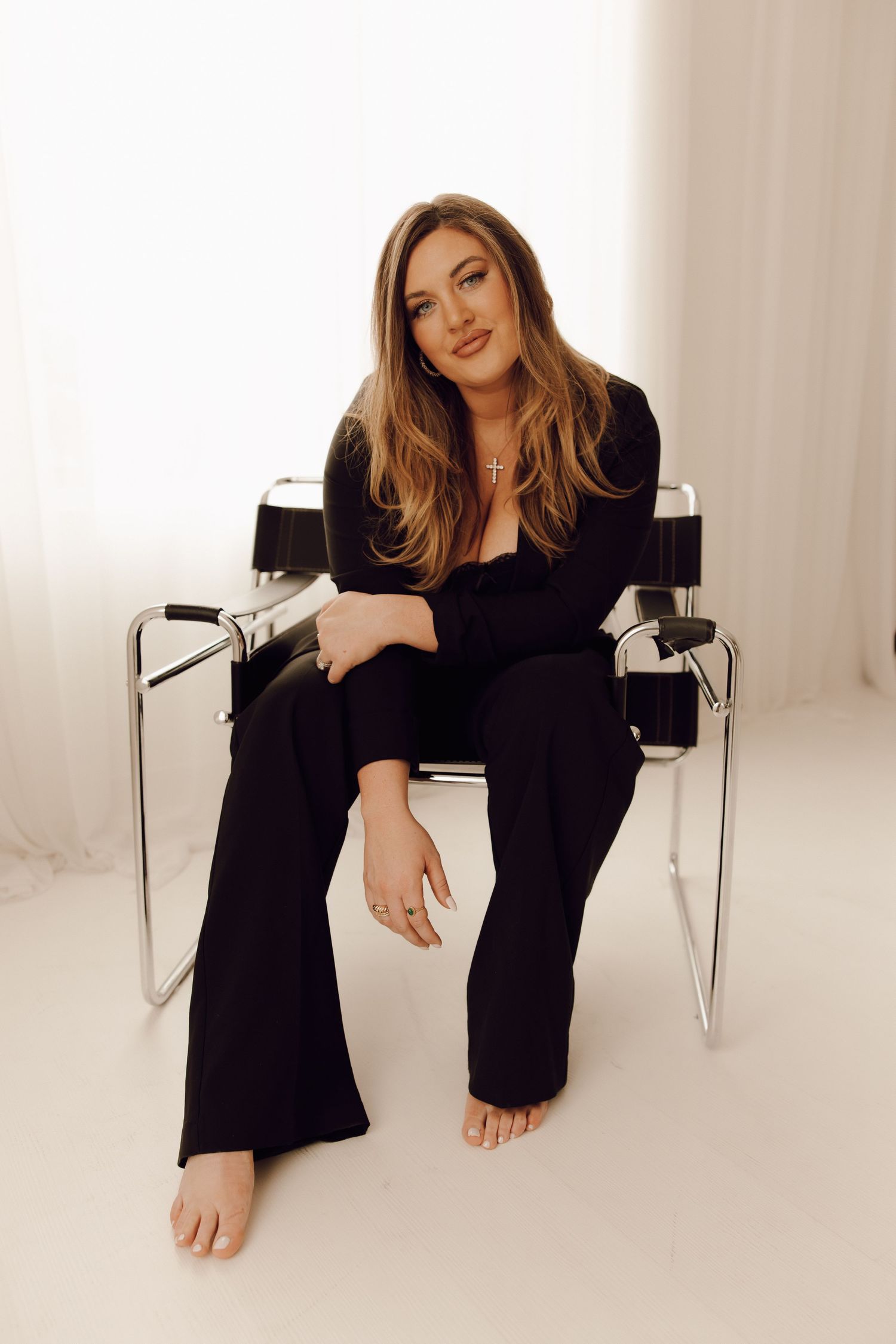 Professional branding photoshoot of a woman entrepreneur in a modern office setting.