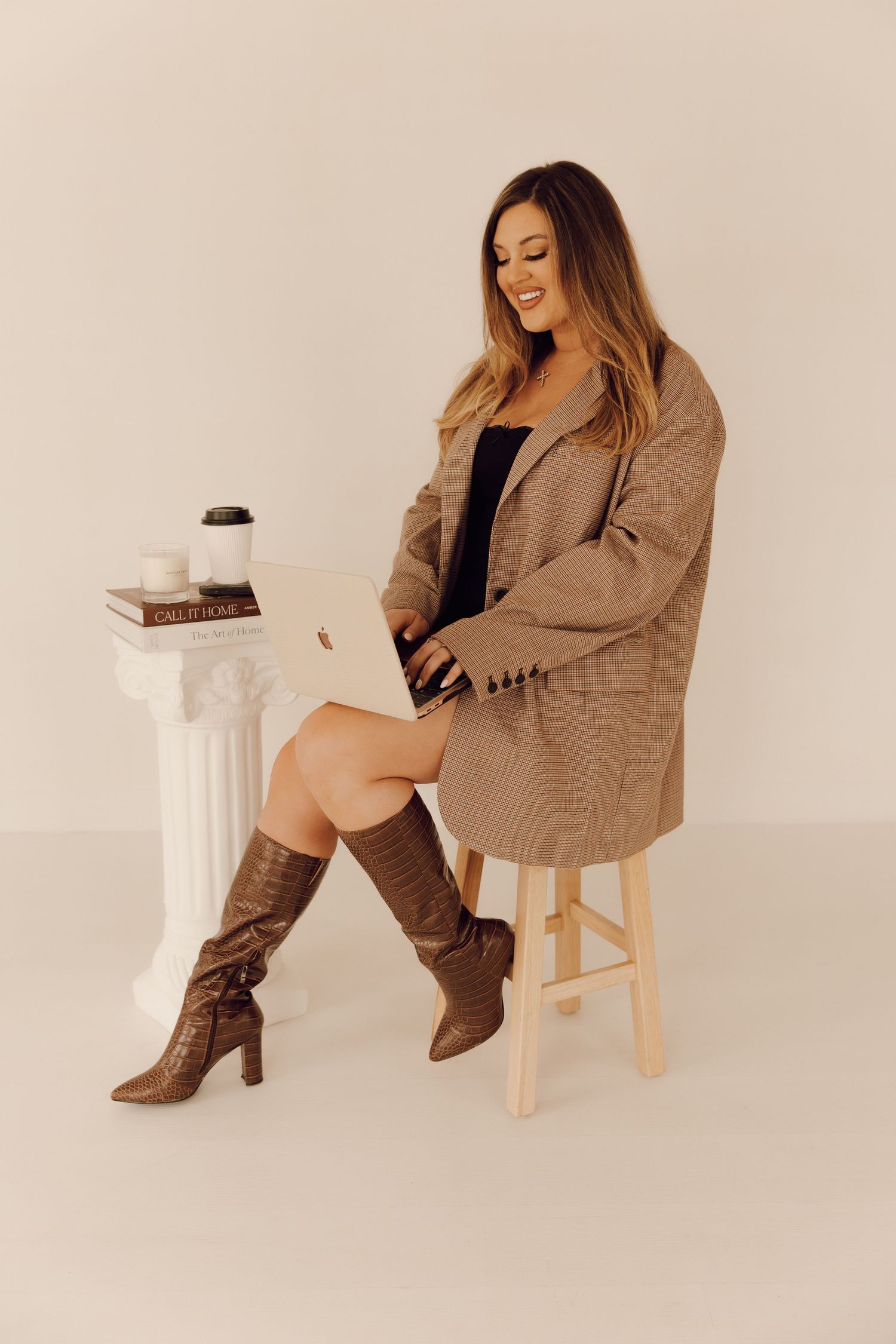 Professional branding photoshoot of a woman entrepreneur in a modern office setting.