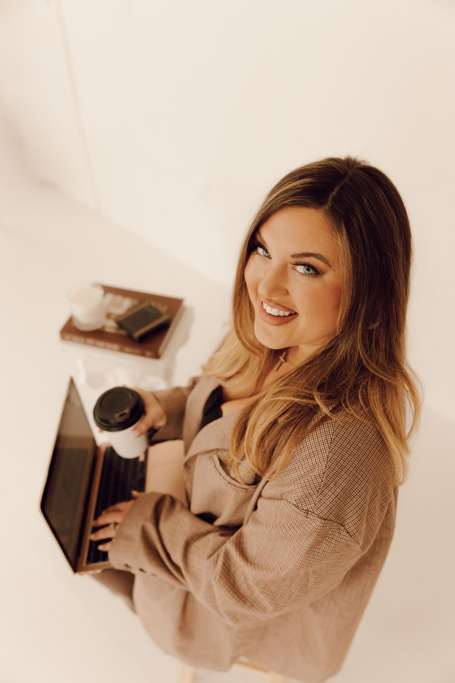 Professional branding photoshoot of a woman entrepreneur in a modern office setting.