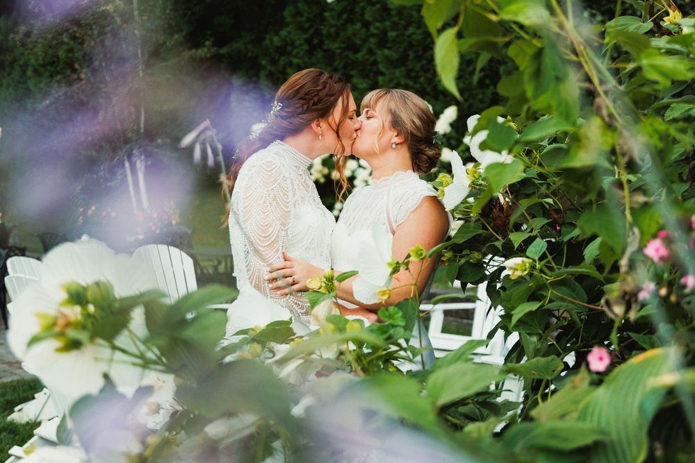 Romantic garden wedding scene with white hydrangeas and greenery.