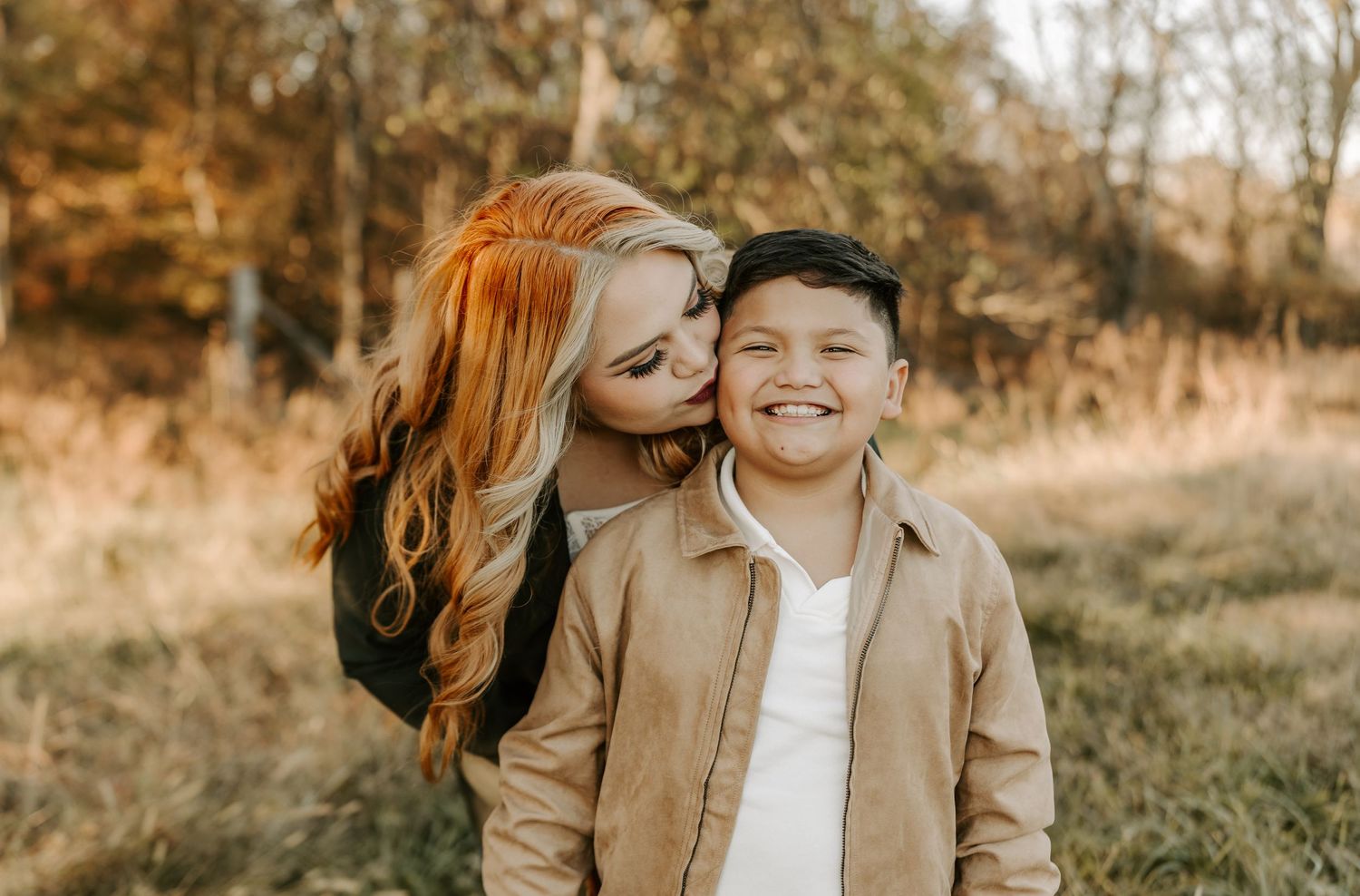 Couple sharing tender moment during autumn outdoor photoshoot.