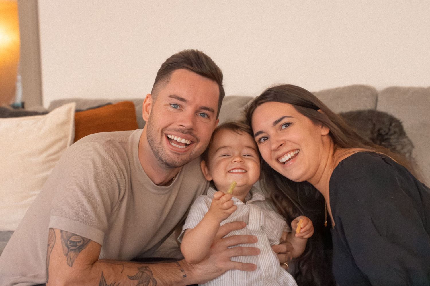 Indoor family photo session in the Greater Phoenix area, featuring a happy family captured in a cozy, natural setting.