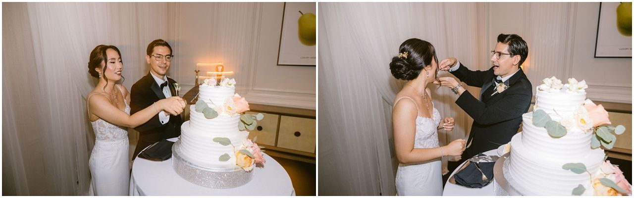 A bride and groom cut their elegant white wedding cake together during their reception celebration.