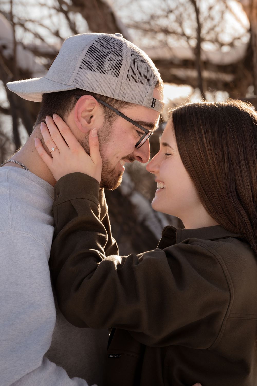 A romantic couple in winter attire share intimate moments together in a series of close-up shots.