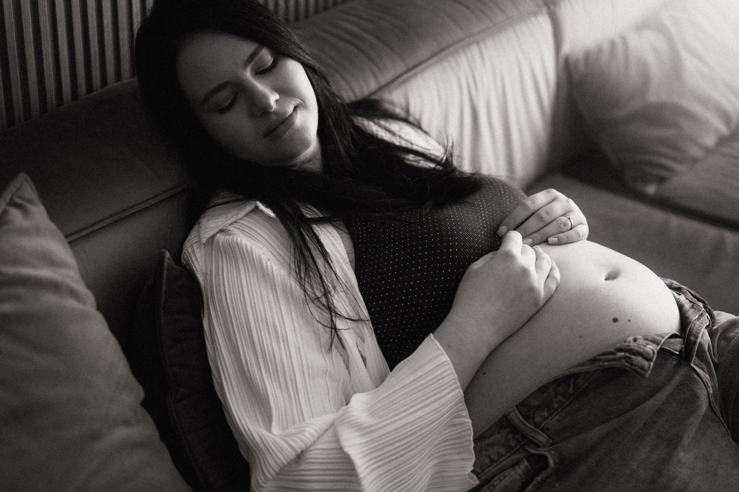 A series of black and white photographs showing someone resting peacefully on a couch or bed.
