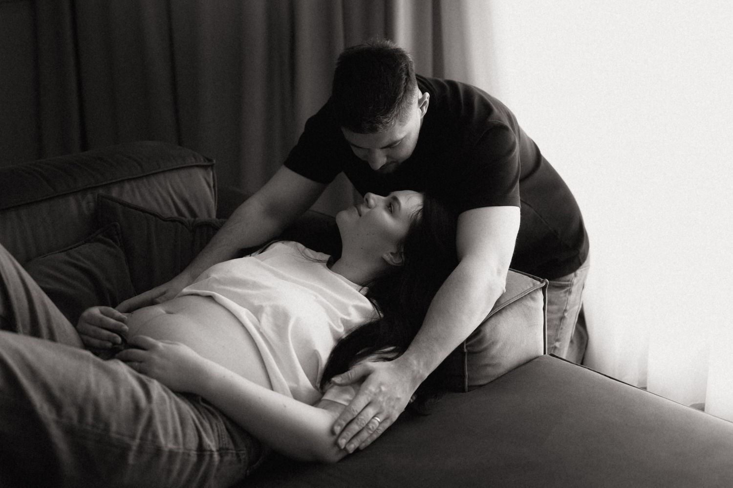 A sequence of black and white photos showing a person lying down receiving a massage therapy treatment.