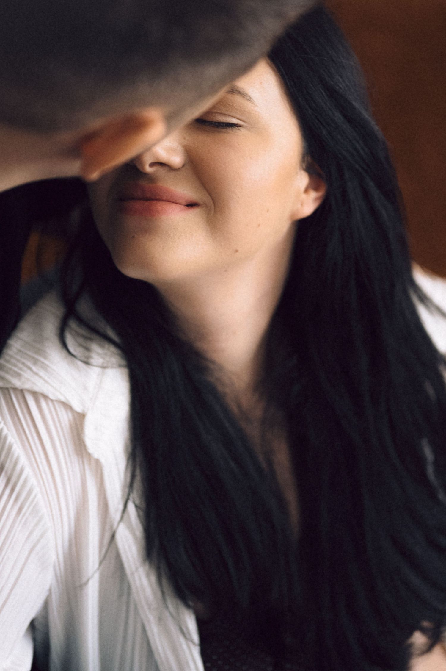 A series of profile photos showing someone with long dark hair wearing a white collared shirt against a warm background.