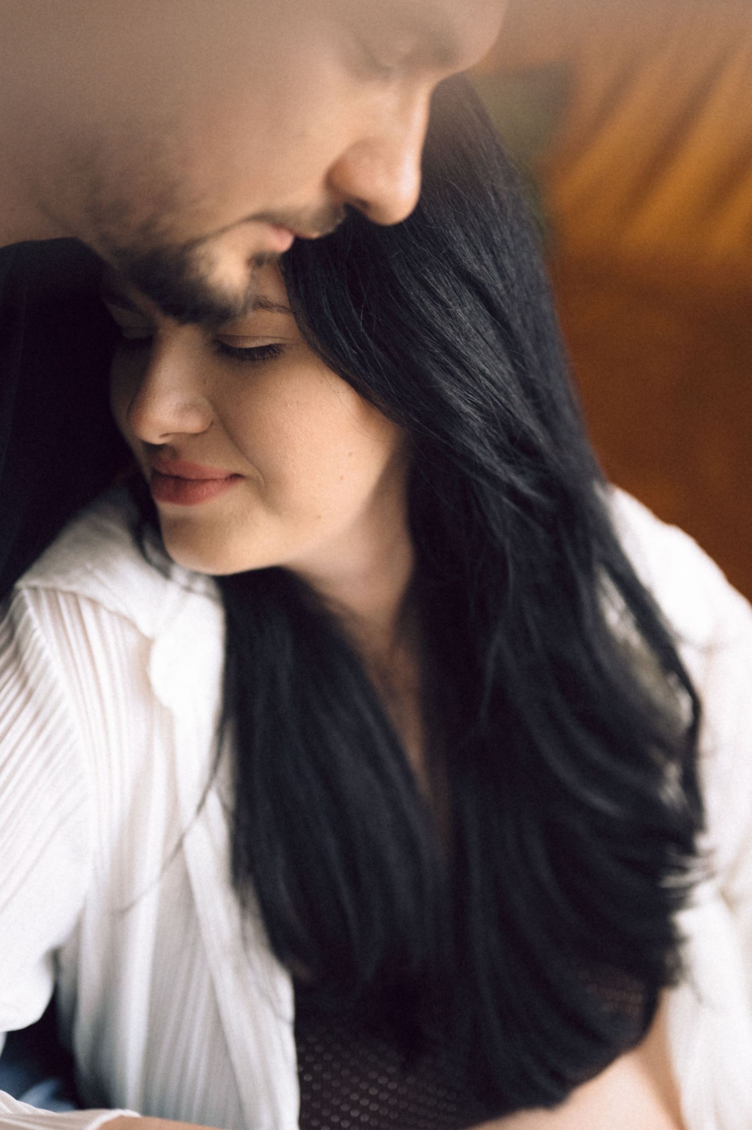 A series of profile shots showing long dark hair against a white top in warm lighting.