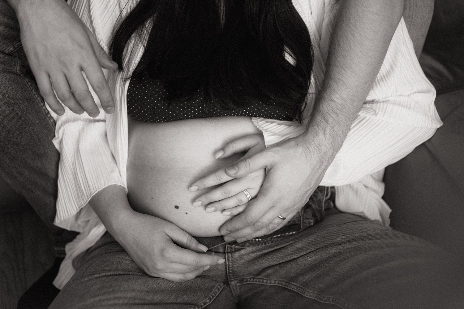 Black and white photo series showing close-up details of hands resting on legs and torso in various poses.
