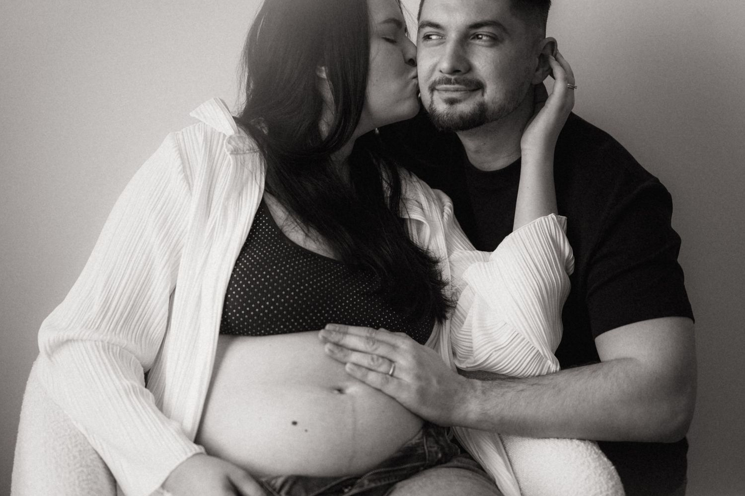 A series of black and white photographs showing intimate moments between two people embracing and interacting together.