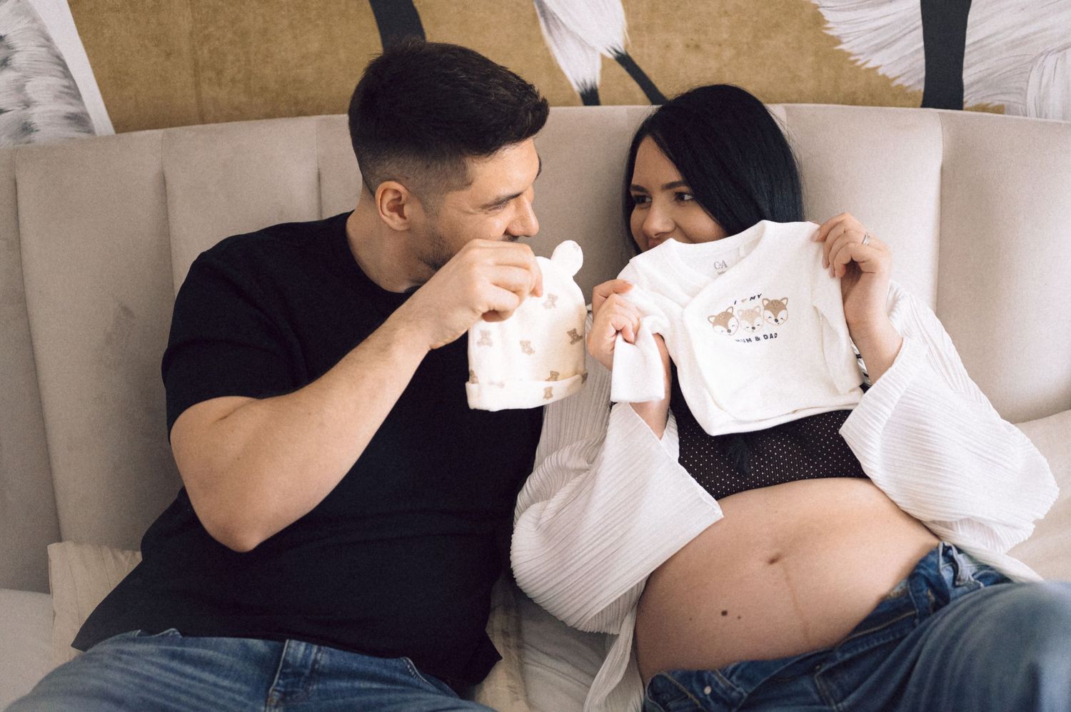 A series of intimate maternity photos showing a couple embracing and touching a pregnant belly.