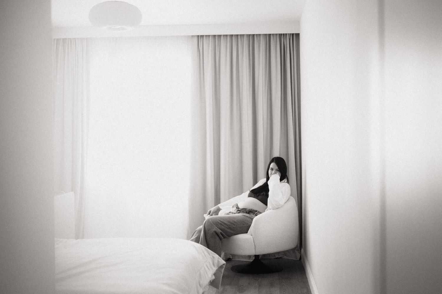 A series of minimalist black and white photographs showing silhouettes and figures against bright window light.