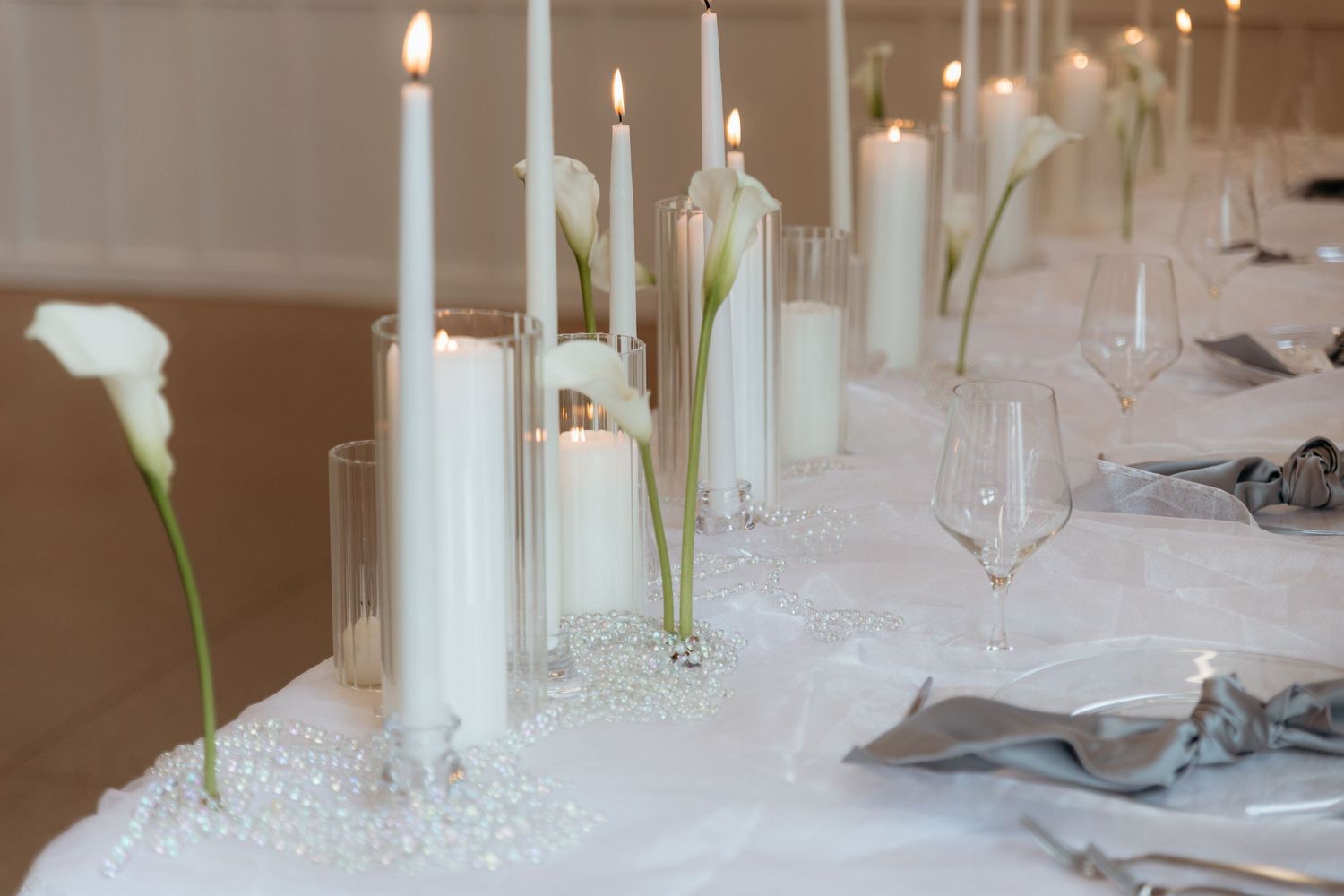 Elegant table setting with white candles and calla lilies for a wedding reception. Ivy House wedding reception. Natural light photographer
