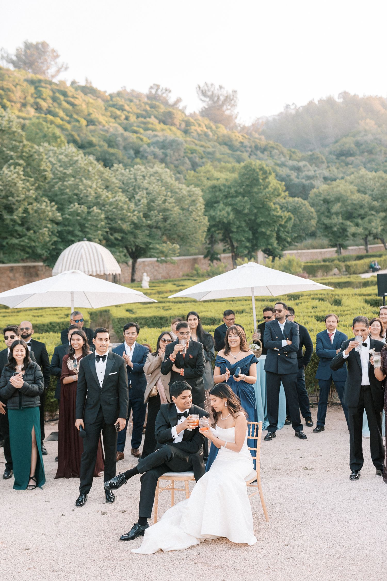 Newlyweds sharing a playful toast surrounded by guests at Portuguese destination wedding, captured by portugal wedding photographer