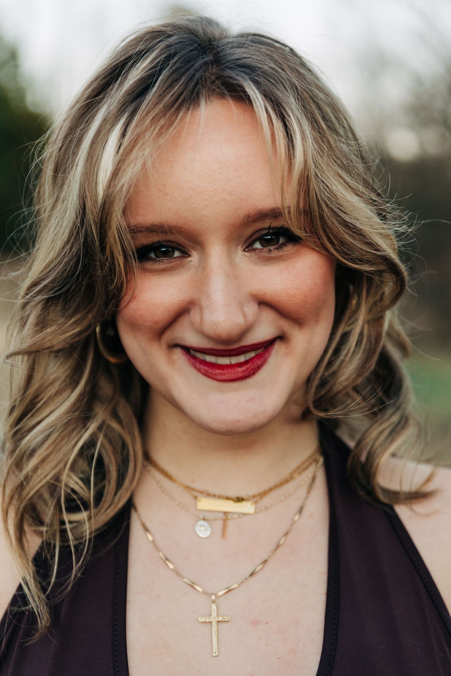 A series of close-up photos showing blonde wavy hair, delicate necklaces, and warm smiles against a soft blurred background.