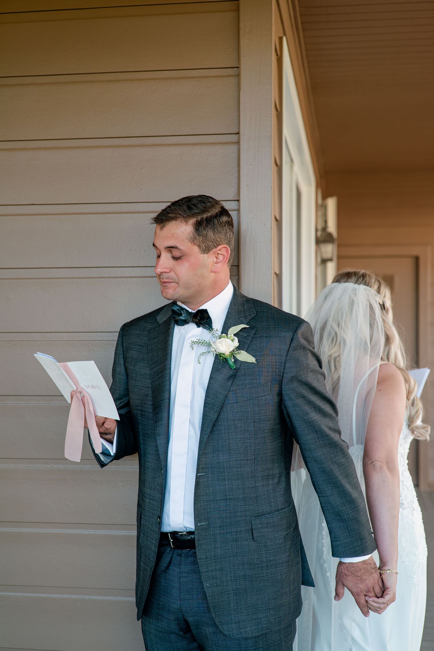A series of wedding photos showing a couple in formal attire sharing a private first look moment before their ceremony.