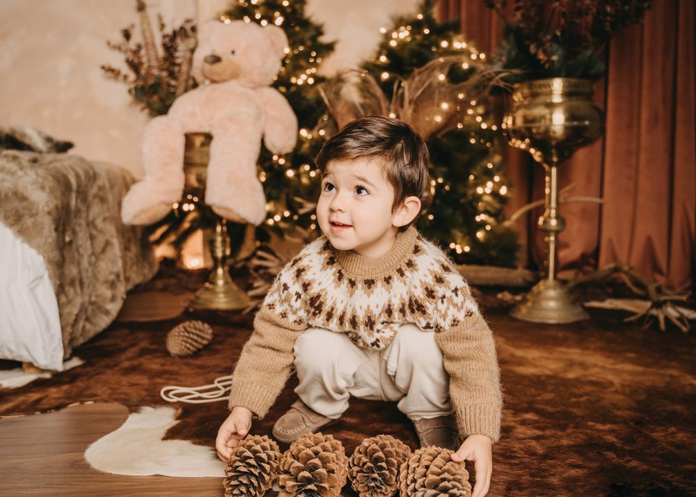 A cozy Christmas setting with a child wearing a Fair Isle sweater surrounded by holiday decorations.