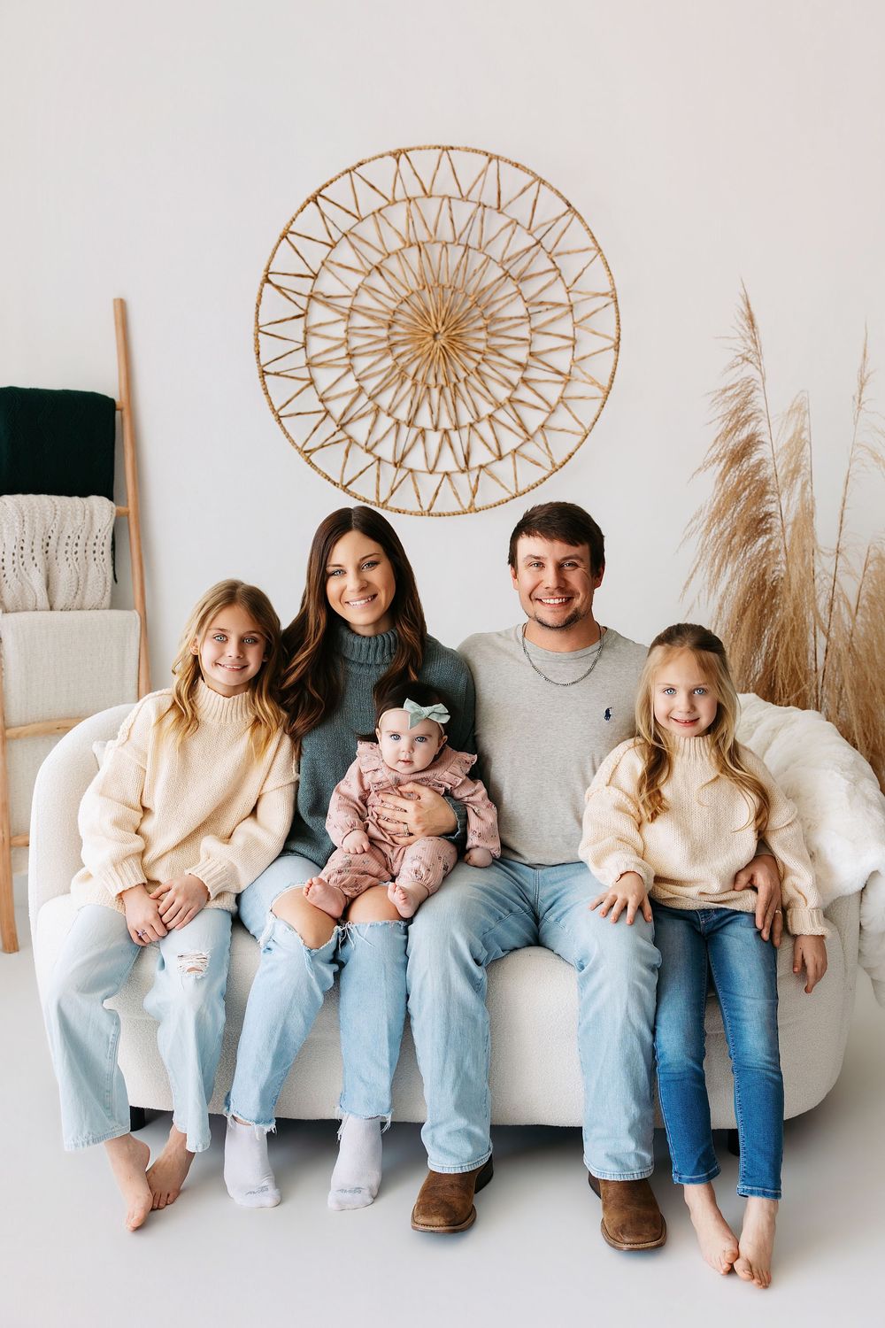 A series of candid family photos showing people sitting together on a white bench with decorative wall art and pampas grass.