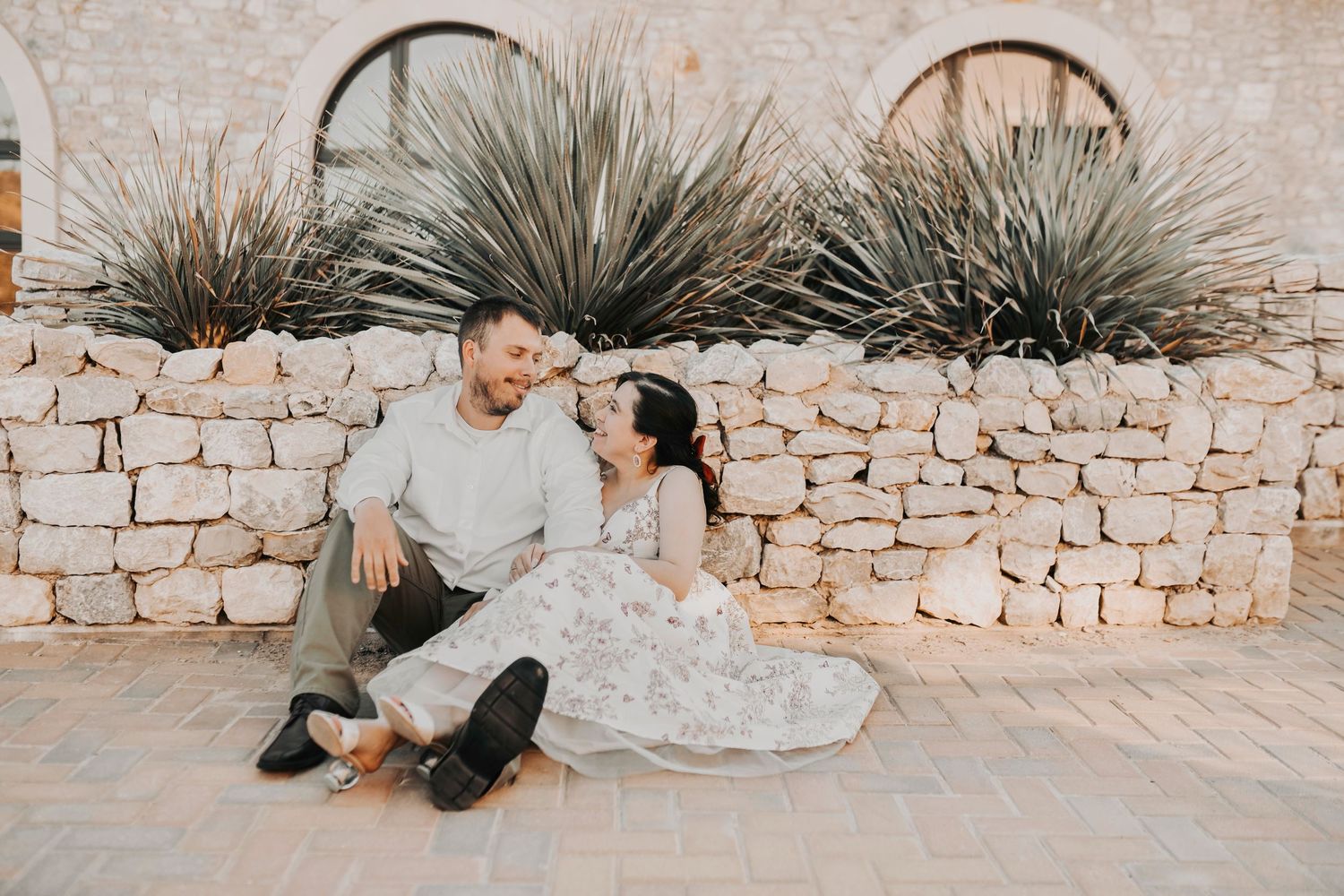 Romantic couple gazing at each other during engagement session at Chapel at Palacios in Westlake Texas