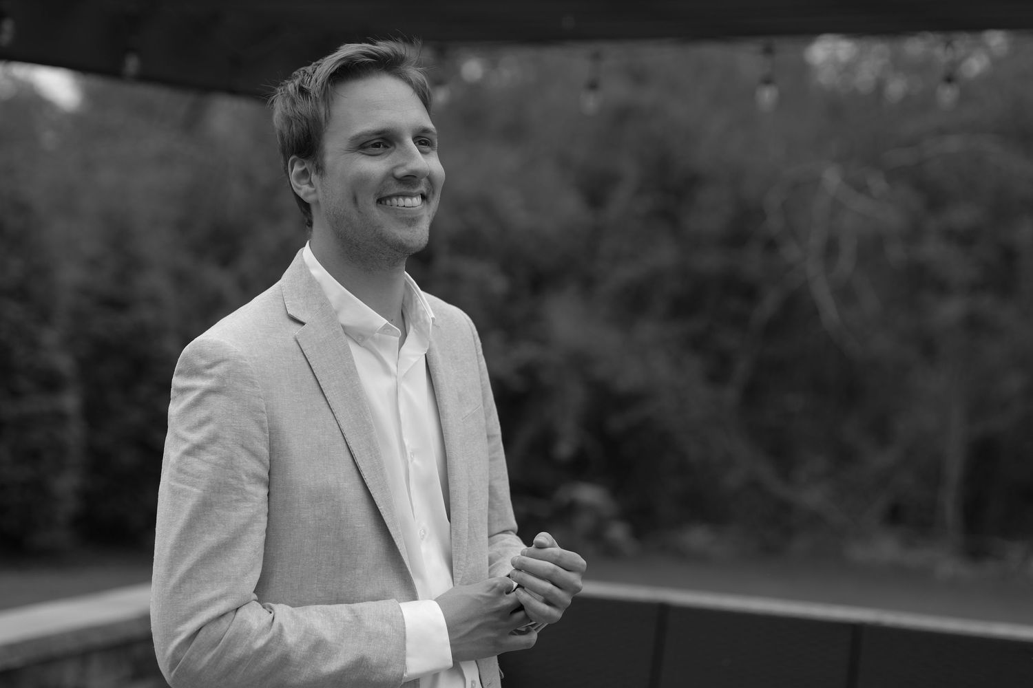 Man in suit smiling off into the distance