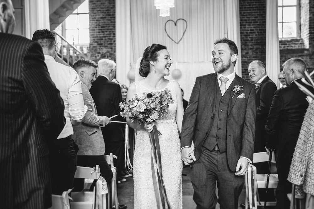 Black and white wedding photos showing a couple and guests celebrating during a traditional ceremony reception.