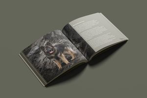 An open book with artistic black and white photography layout displayed on a dark surface.