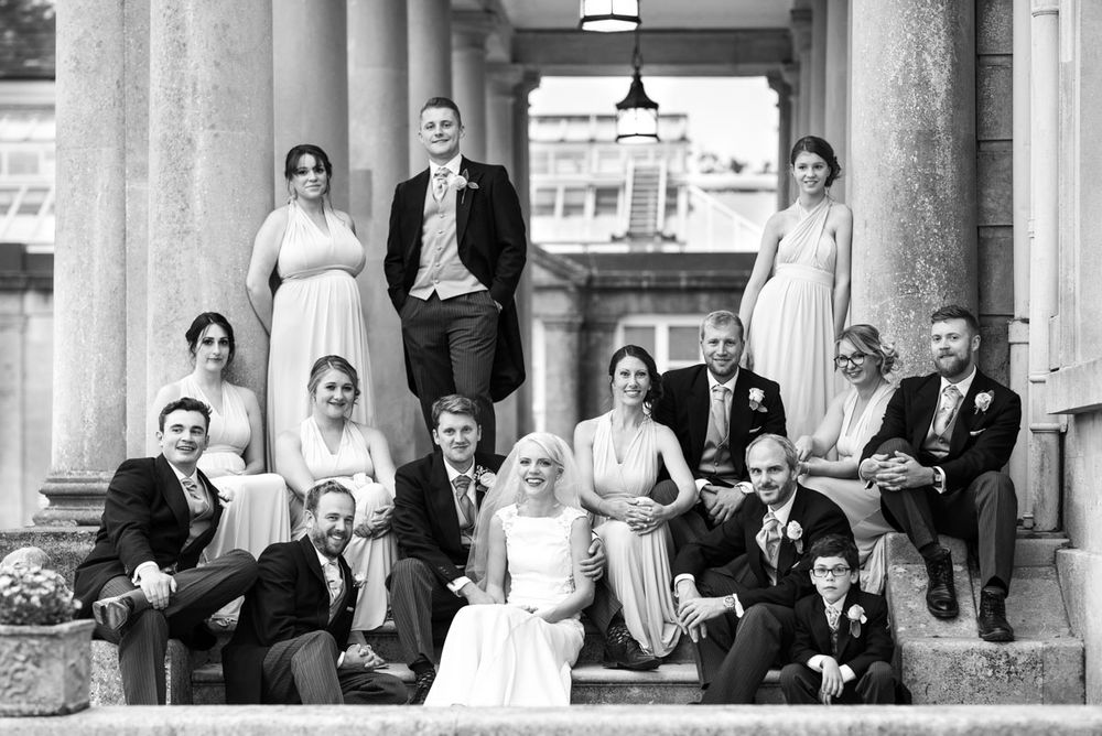 Bridesmaids and groomsmen arranged elegantly on steps at Buxted Park Hotel