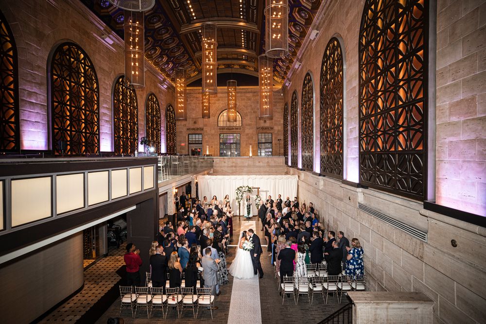 Elegant wedding ceremony in Union Trust with high ceilings, stone walls and guests at a Union Trust wedding
