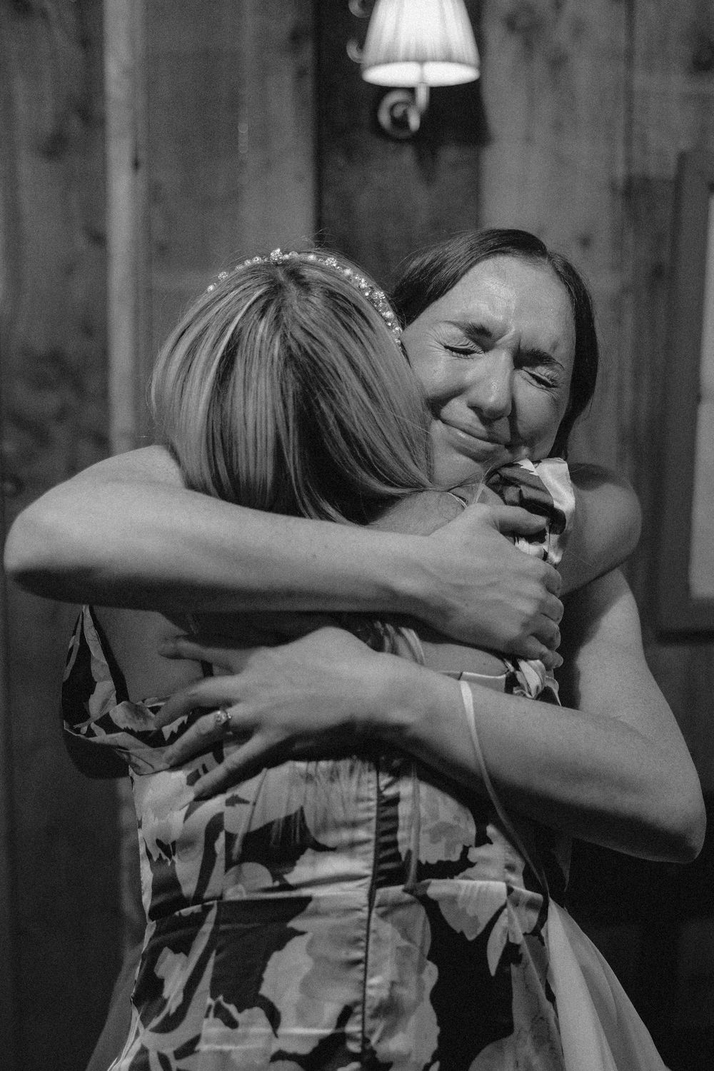 A black and white photo series shows a sequence of two people embracing in an emotional moment.