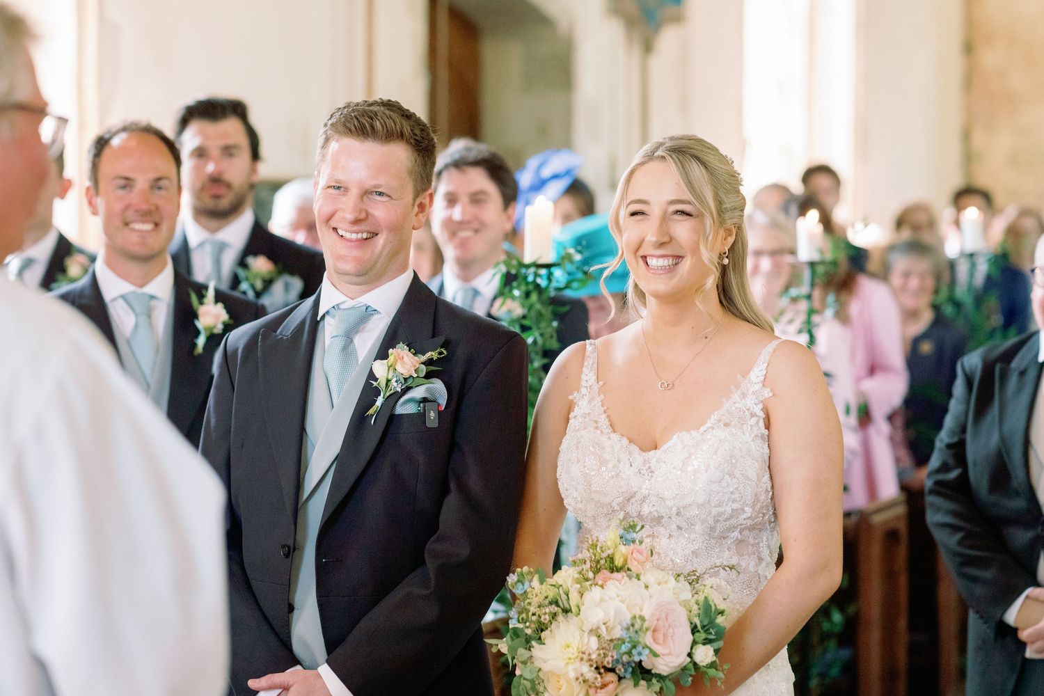 Bride and Groom at the top of the aisle, with big smiles in their wedding, photographed by Maddie Waters Photography