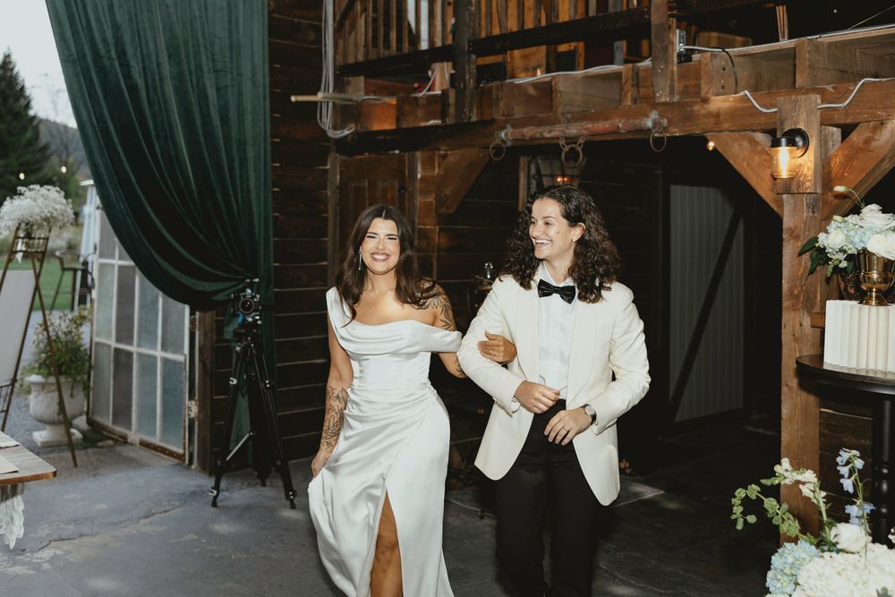 Bride and groom share intimate moments during their wedding celebration in a rustic indoor venue.